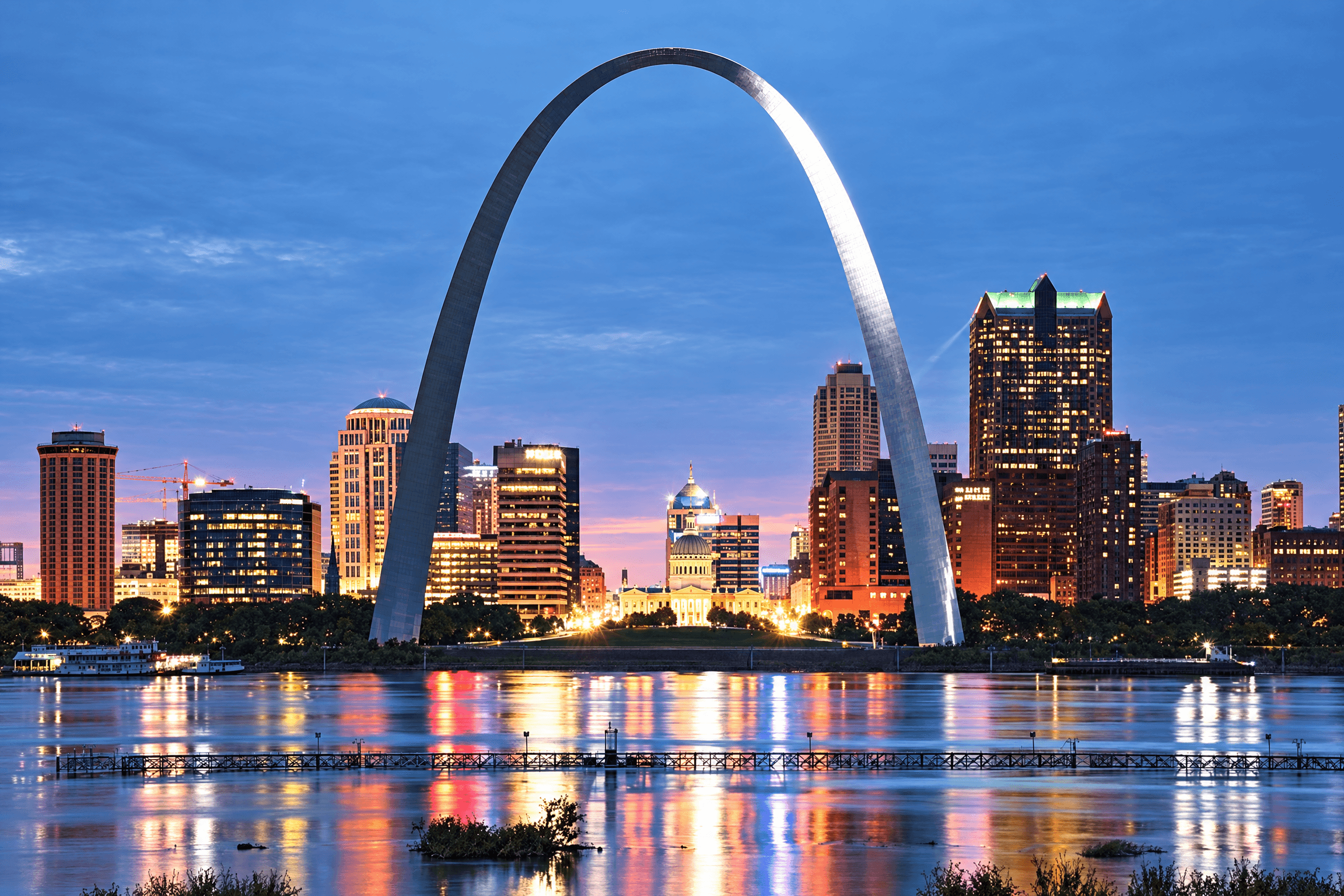 Gateway Arch & downtown St. Louis reflected in the Mississippi River at dusk
